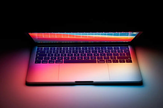 MacBook with keyboard lit up by the screen